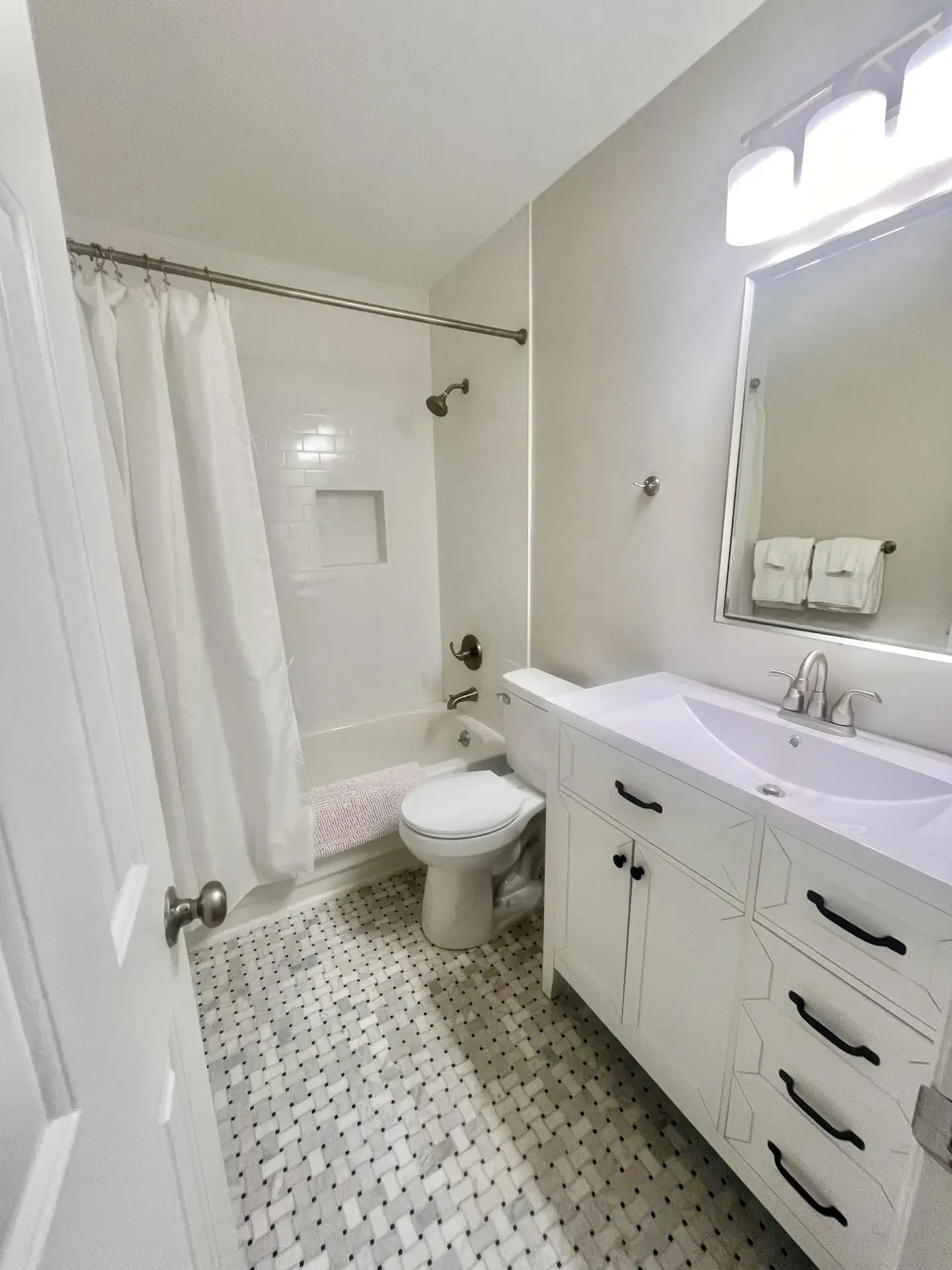 Floating vanity with matte-black fixtures